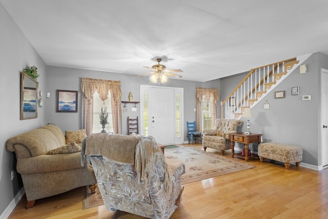 living room featuring ceiling fan and hardwood / wood-style flooring