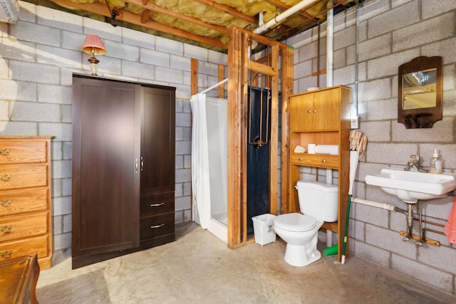 bathroom featuring toilet and concrete flooring