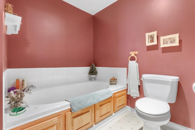 bathroom with a washtub and toilet