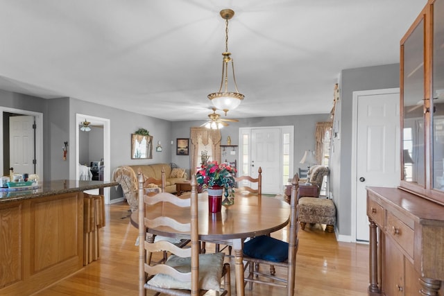 dining room with ceiling fan and light hardwood / wood-style floors