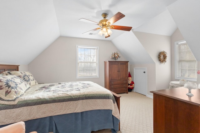 bedroom featuring ceiling fan, light colored carpet, and vaulted ceiling