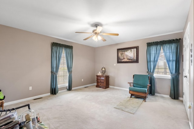 sitting room featuring light carpet and ceiling fan