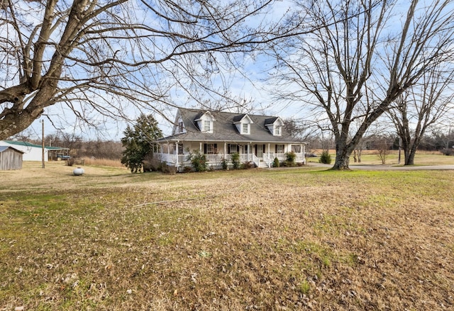 cape cod-style house with a porch and a front lawn