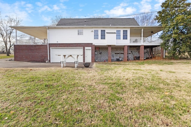 back of house with a yard and a garage