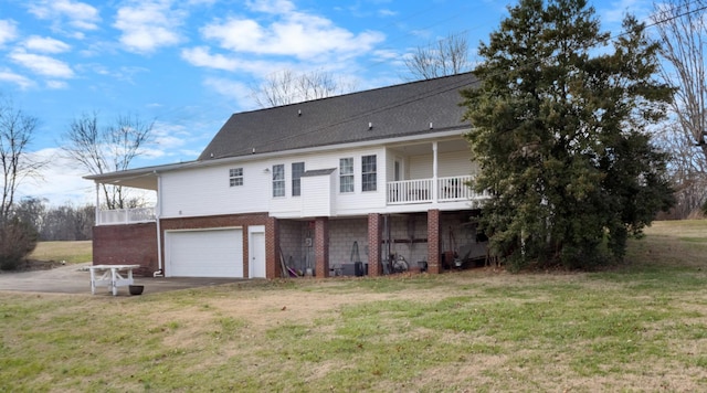 back of house with a yard and a garage