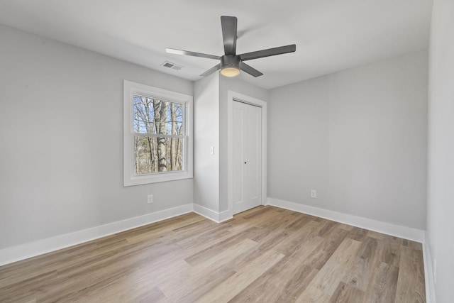 unfurnished bedroom with visible vents, baseboards, light wood-style floors, a closet, and a ceiling fan