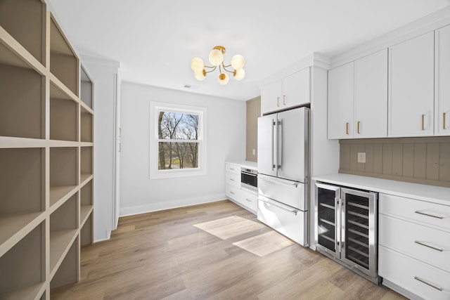 interior space featuring wine cooler, light wood-style flooring, high quality fridge, and light countertops