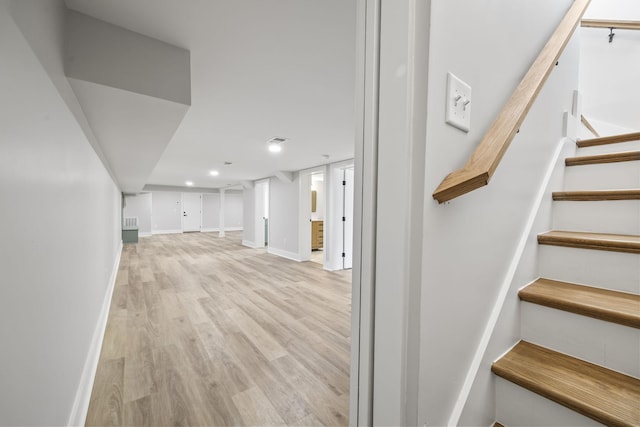 staircase featuring recessed lighting, visible vents, baseboards, and wood finished floors