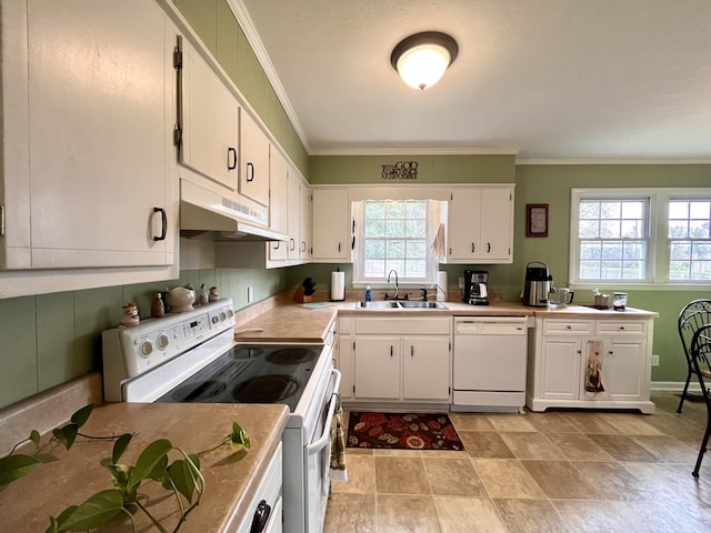 kitchen featuring a wealth of natural light, white cabinetry, sink, white appliances, and ornamental molding