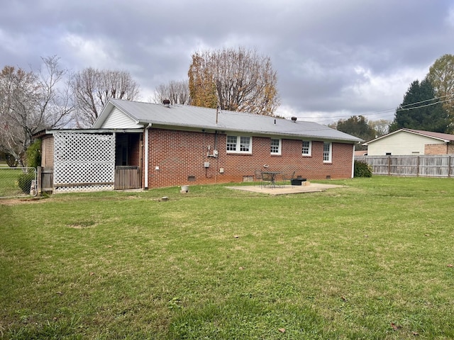 back of house featuring a patio and a lawn