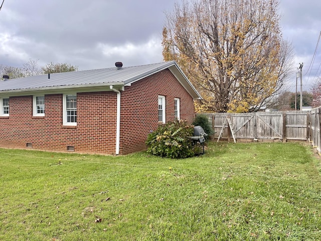 view of home's exterior with a yard