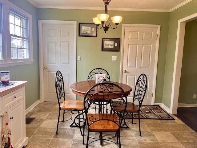 dining area featuring a chandelier and ornamental molding