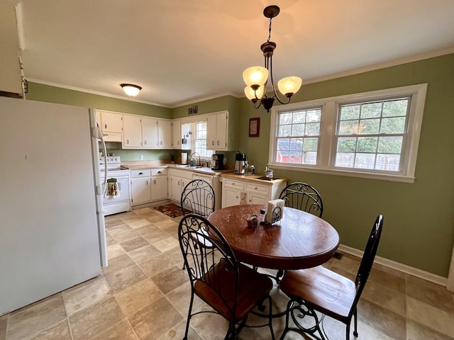 dining room featuring a notable chandelier, ornamental molding, and sink