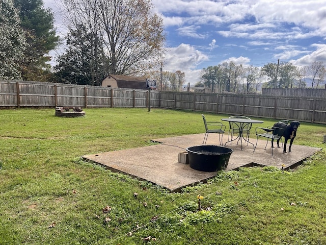 view of yard with a fire pit and a patio area