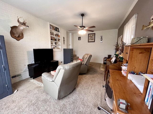 living room with light carpet, built in features, ceiling fan, and brick wall