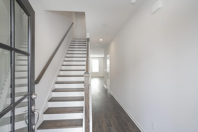 stairway with hardwood / wood-style floors