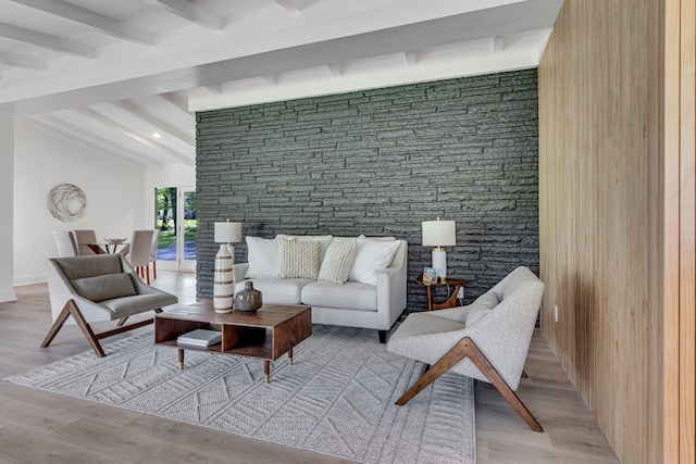 living room featuring beamed ceiling and light wood-type flooring