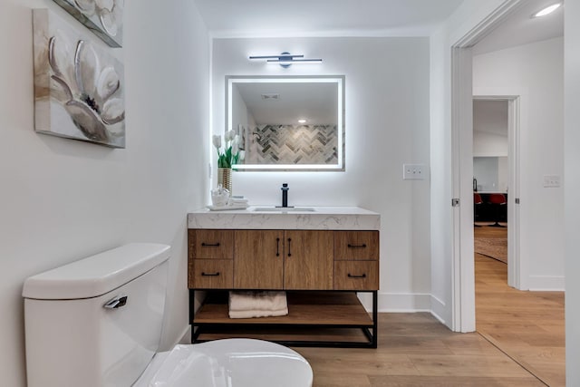 bathroom featuring hardwood / wood-style floors, vanity, and toilet