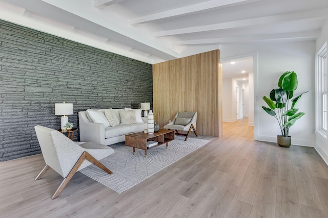 living room with lofted ceiling with beams and light wood-type flooring