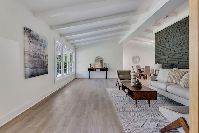 living room with vaulted ceiling with beams and light hardwood / wood-style floors