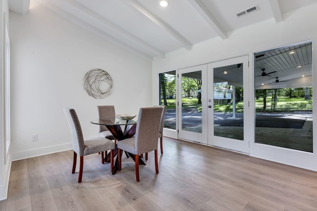 dining space with vaulted ceiling with beams, ceiling fan, french doors, and light wood-type flooring