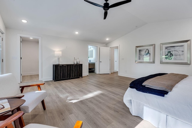 bedroom featuring ensuite bath, ceiling fan, light hardwood / wood-style flooring, and lofted ceiling