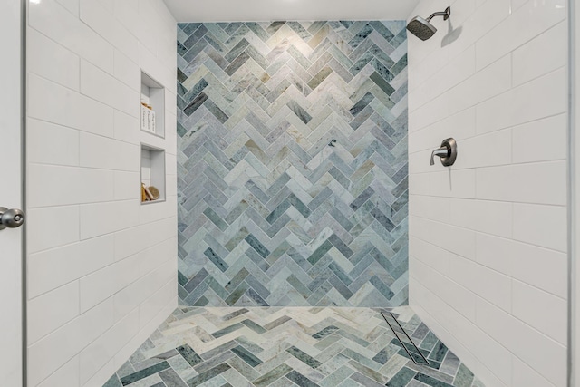 bathroom with tiled shower