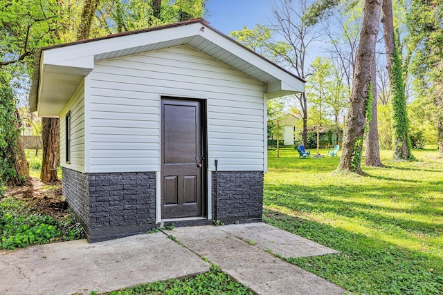 view of outbuilding with a lawn