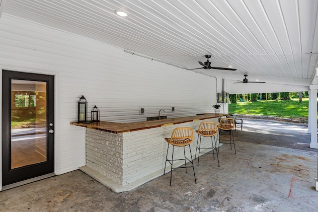 view of patio / terrace featuring exterior bar and ceiling fan