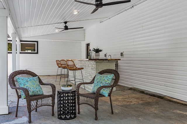 view of patio / terrace with ceiling fan and an outdoor bar