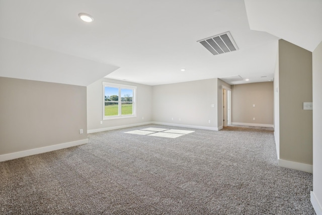 bonus room with carpet floors and lofted ceiling