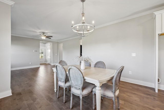 dining space with dark wood-type flooring, ceiling fan with notable chandelier, and ornamental molding