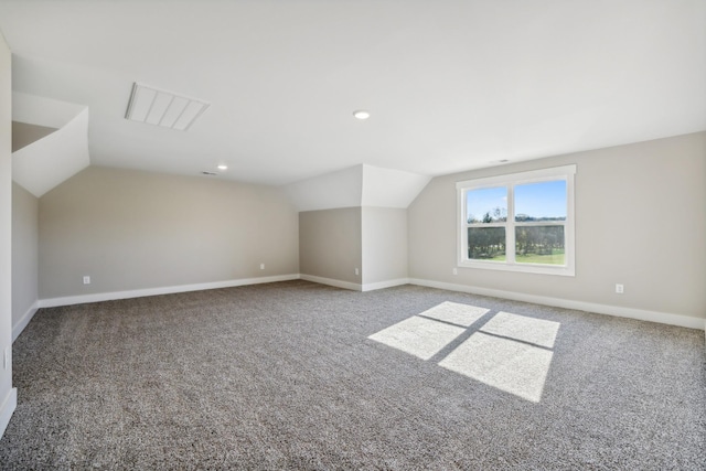 bonus room with carpet flooring and lofted ceiling