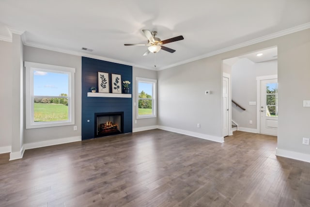 unfurnished living room with ceiling fan, dark hardwood / wood-style floors, ornamental molding, and a fireplace