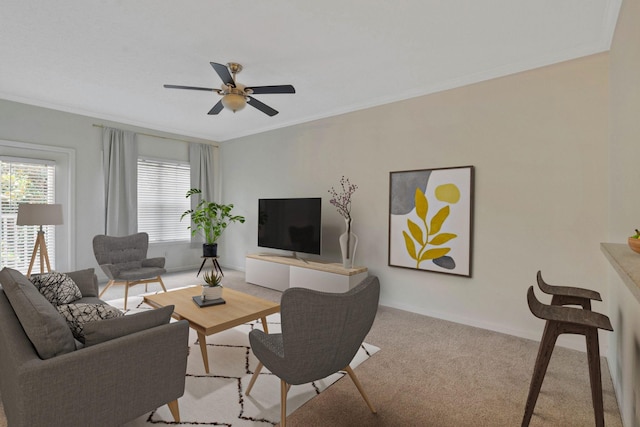 carpeted living room featuring crown molding and ceiling fan