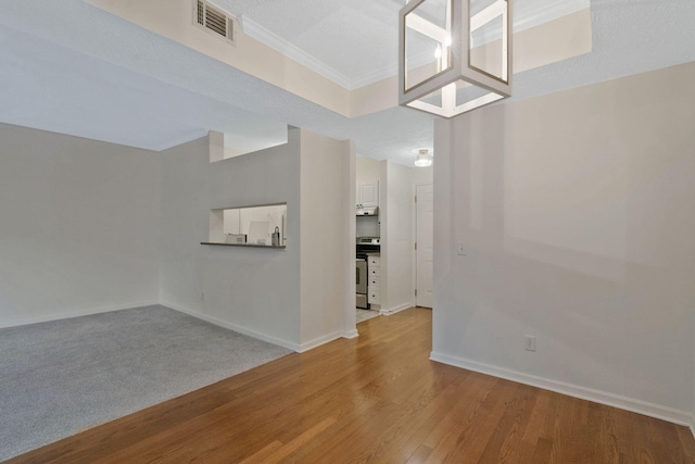 empty room with light hardwood / wood-style floors and a textured ceiling