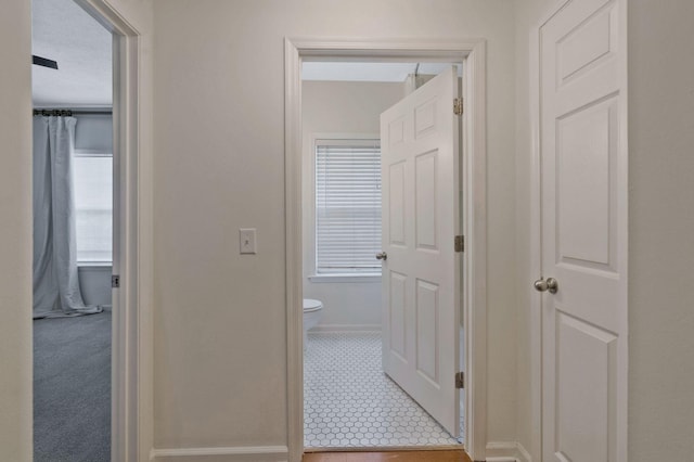 hall featuring a textured ceiling