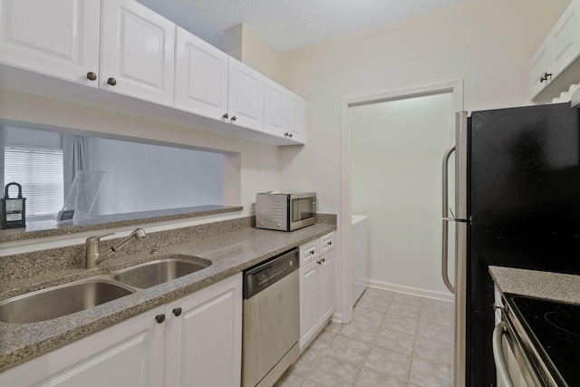 kitchen with light stone counters, white cabinetry, sink, and appliances with stainless steel finishes