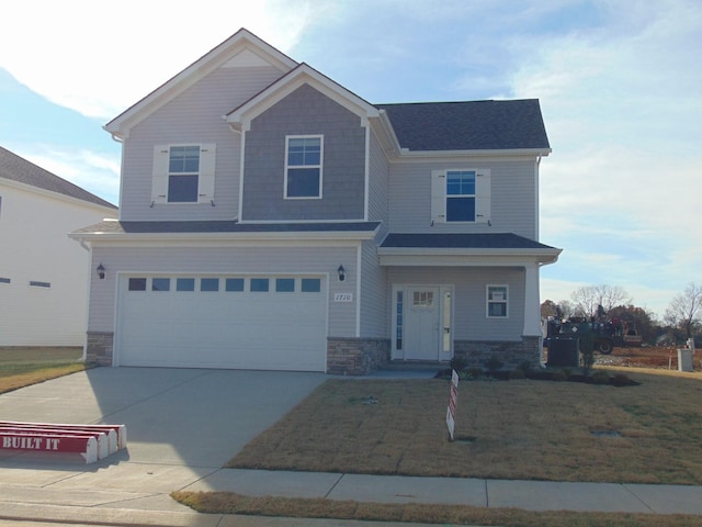 view of front of house featuring a front lawn, central AC unit, and a garage