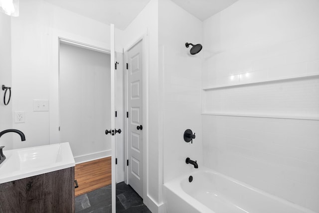 bathroom featuring vanity, wood-type flooring, and washtub / shower combination