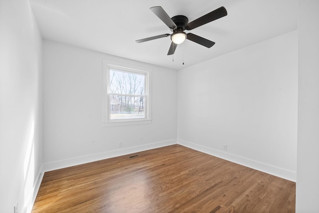 spare room with hardwood / wood-style flooring and ceiling fan