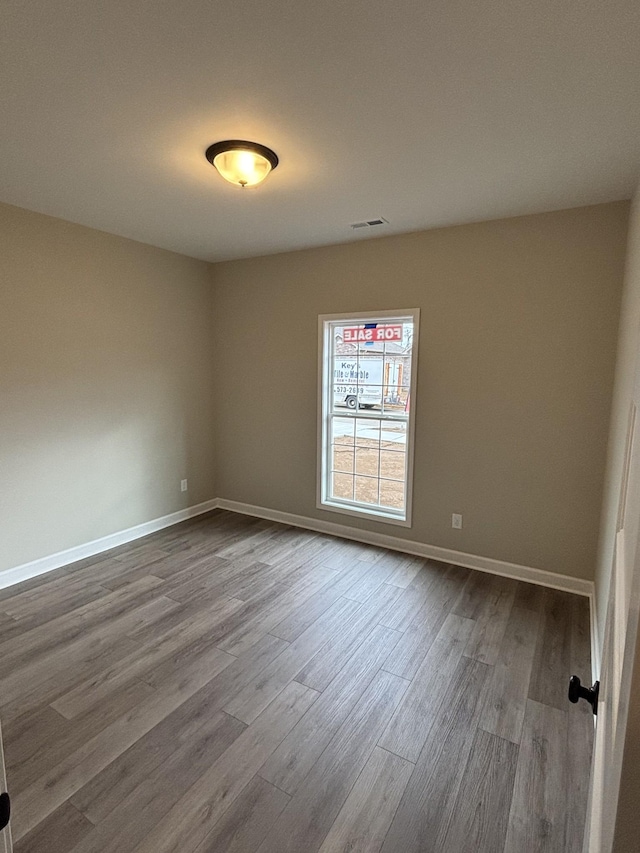 empty room with hardwood / wood-style floors