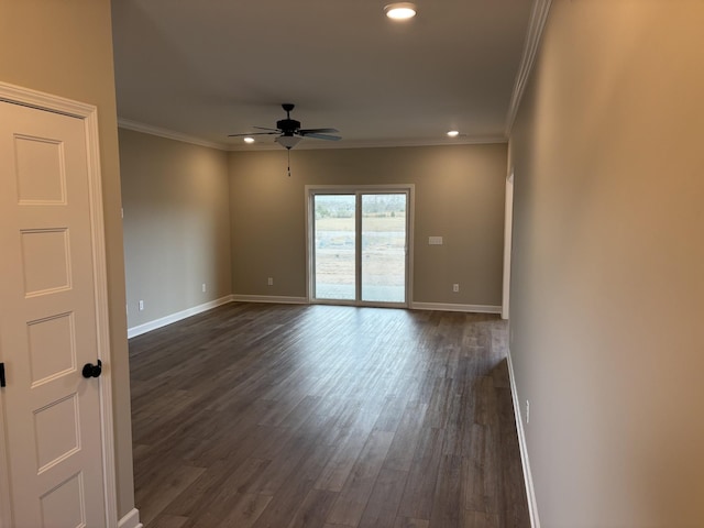 spare room featuring dark hardwood / wood-style flooring, ornamental molding, and ceiling fan