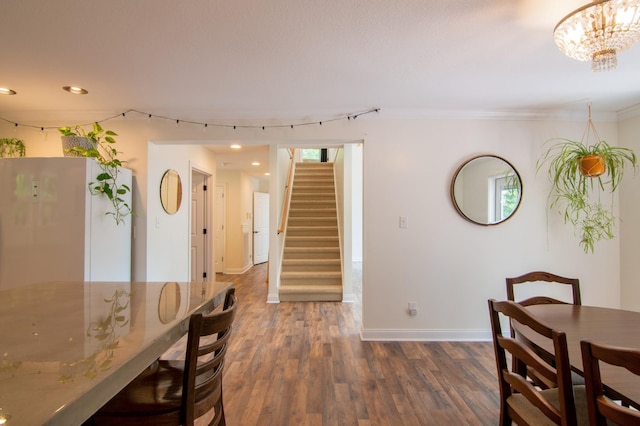 dining room featuring ornamental molding, dark hardwood / wood-style flooring, and a chandelier