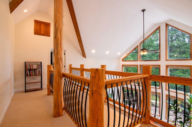 hallway with lofted ceiling and light carpet