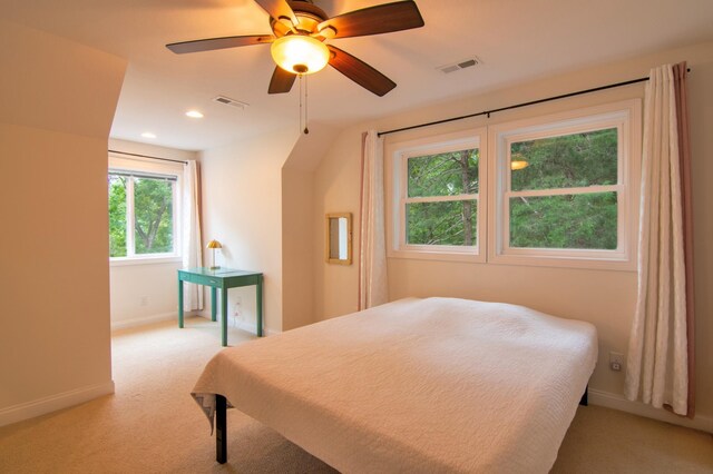 carpeted bedroom featuring vaulted ceiling and ceiling fan