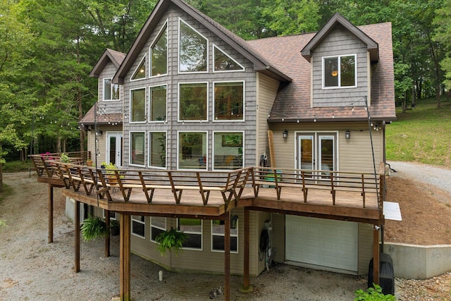 rear view of house with a garage and a deck