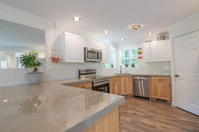 kitchen with sink, crown molding, light brown cabinets, appliances with stainless steel finishes, and hardwood / wood-style floors