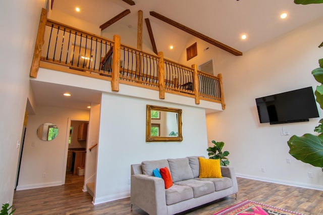 living room with a high ceiling, dark hardwood / wood-style flooring, and beamed ceiling