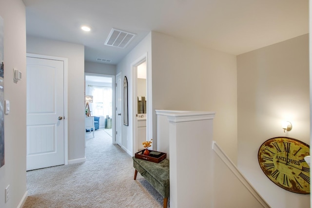 hall with light colored carpet